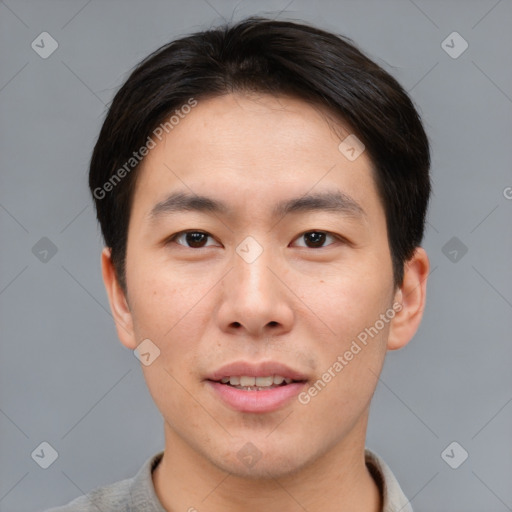 Joyful asian young-adult male with short  brown hair and brown eyes