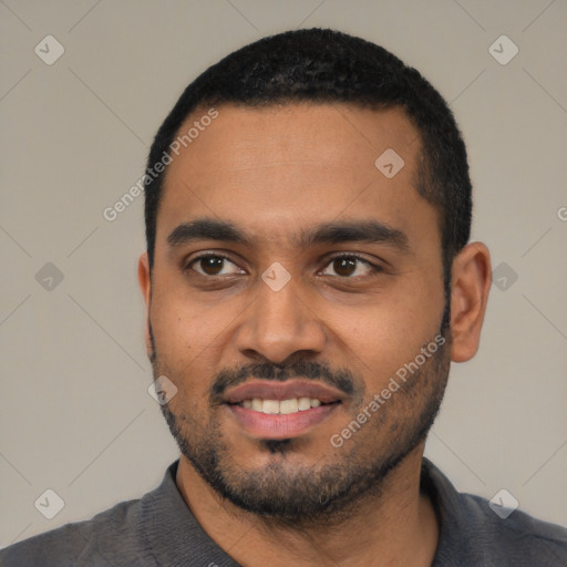 Joyful black young-adult male with short  black hair and brown eyes