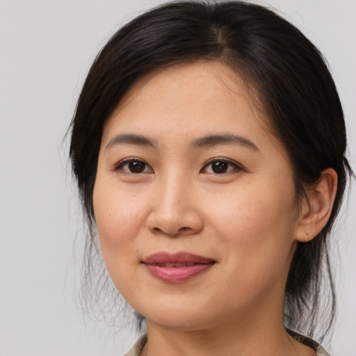 Joyful asian young-adult female with medium  brown hair and brown eyes