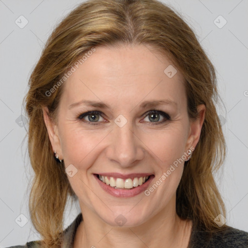 Joyful white adult female with medium  brown hair and brown eyes