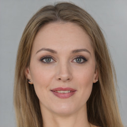 Joyful white young-adult female with long  brown hair and grey eyes