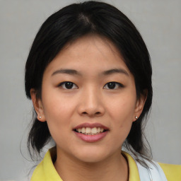 Joyful asian young-adult female with medium  black hair and brown eyes