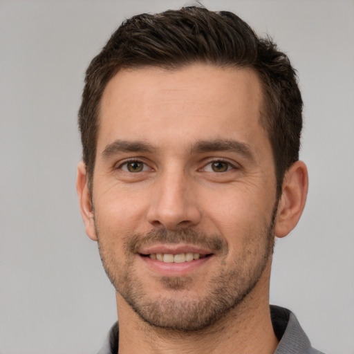 Joyful white young-adult male with short  brown hair and brown eyes