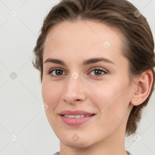 Joyful white young-adult female with medium  brown hair and grey eyes