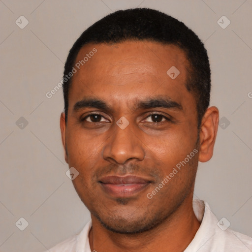 Joyful black young-adult male with short  black hair and brown eyes