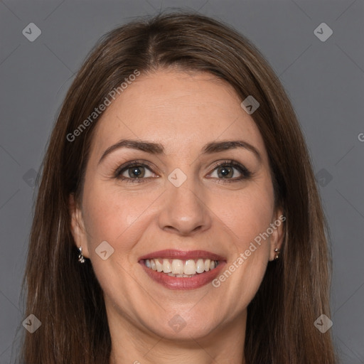 Joyful white adult female with long  brown hair and brown eyes