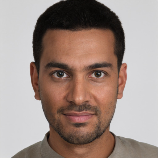 Joyful white young-adult male with short  black hair and brown eyes