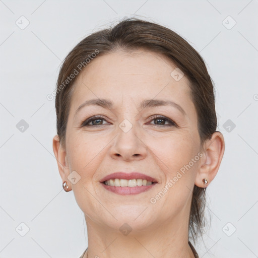 Joyful white adult female with medium  brown hair and brown eyes