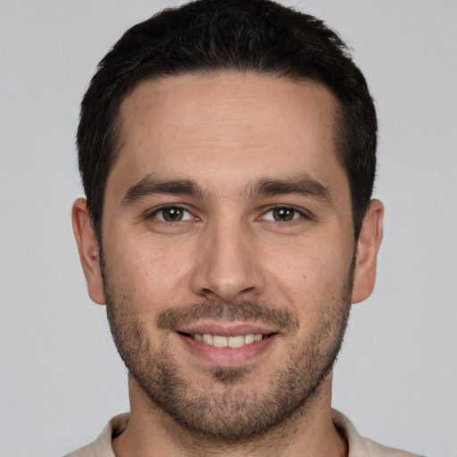 Joyful white young-adult male with short  brown hair and brown eyes