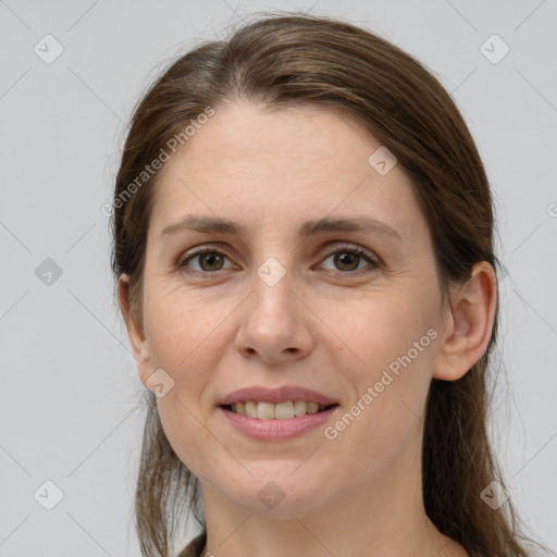 Joyful white young-adult female with long  brown hair and grey eyes