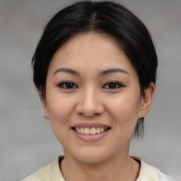 Joyful asian young-adult female with medium  brown hair and brown eyes