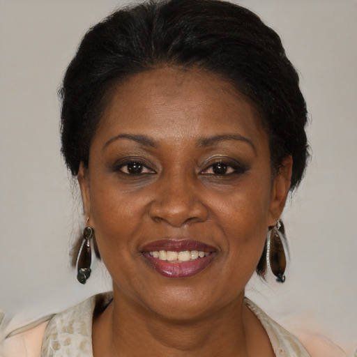 Joyful black adult female with medium  brown hair and brown eyes