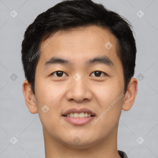 Joyful asian young-adult male with short  brown hair and brown eyes