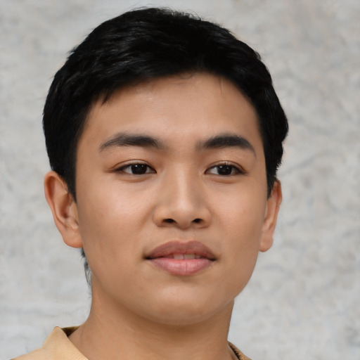 Joyful asian young-adult male with short  black hair and brown eyes