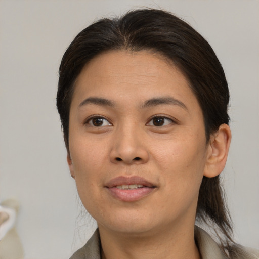 Joyful asian young-adult female with medium  brown hair and brown eyes