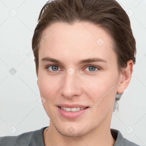 Joyful white young-adult female with short  brown hair and grey eyes