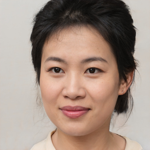 Joyful asian young-adult female with medium  brown hair and brown eyes