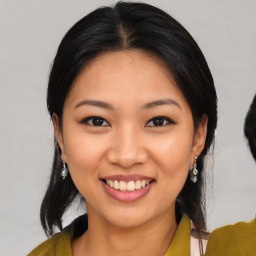 Joyful asian young-adult female with medium  black hair and brown eyes