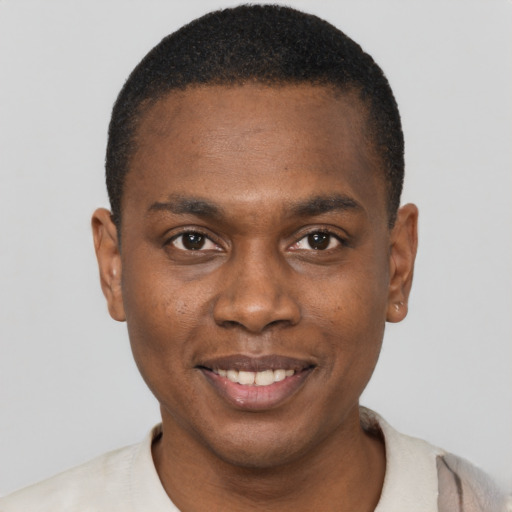 Joyful black young-adult male with short  brown hair and brown eyes