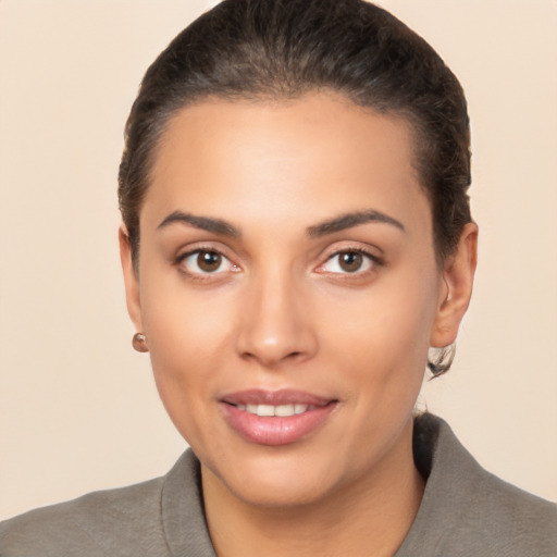 Joyful latino young-adult female with short  brown hair and brown eyes