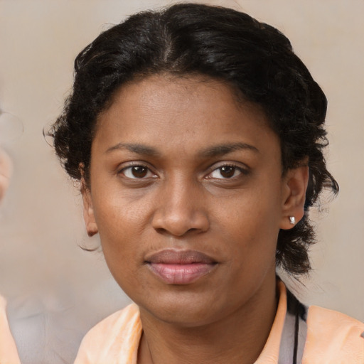 Joyful black young-adult female with medium  brown hair and brown eyes