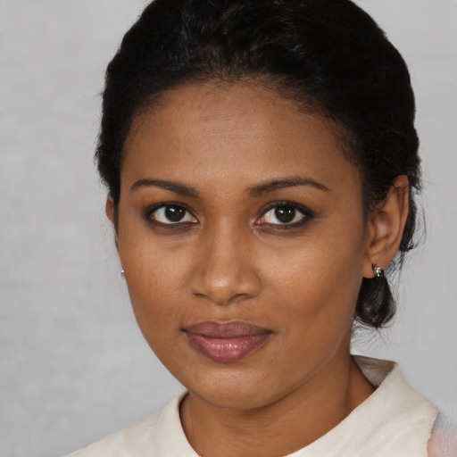 Joyful black young-adult female with short  brown hair and brown eyes