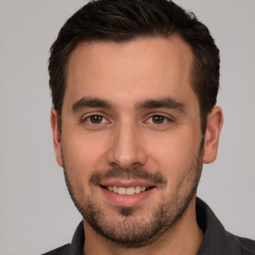 Joyful white young-adult male with short  brown hair and brown eyes