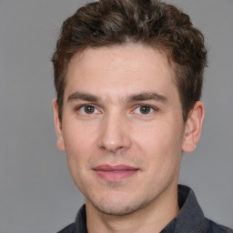 Joyful white young-adult male with short  brown hair and brown eyes