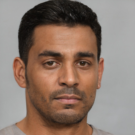 Neutral latino young-adult male with short  black hair and brown eyes