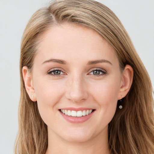 Joyful white young-adult female with long  brown hair and blue eyes