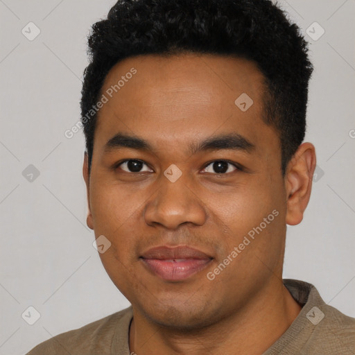 Joyful black young-adult male with short  black hair and brown eyes