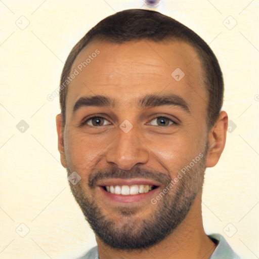 Joyful white young-adult male with short  black hair and brown eyes