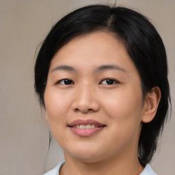 Joyful asian young-adult female with medium  black hair and brown eyes