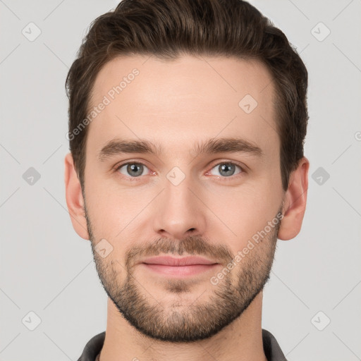 Joyful white young-adult male with short  brown hair and grey eyes