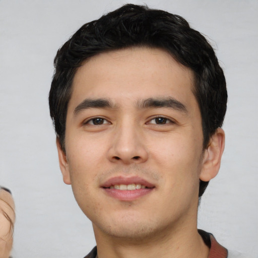 Joyful asian young-adult male with short  black hair and brown eyes