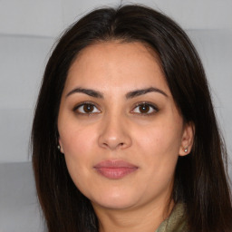 Joyful white young-adult female with long  brown hair and brown eyes