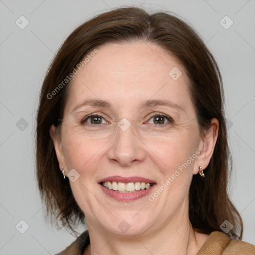 Joyful white adult female with medium  brown hair and grey eyes