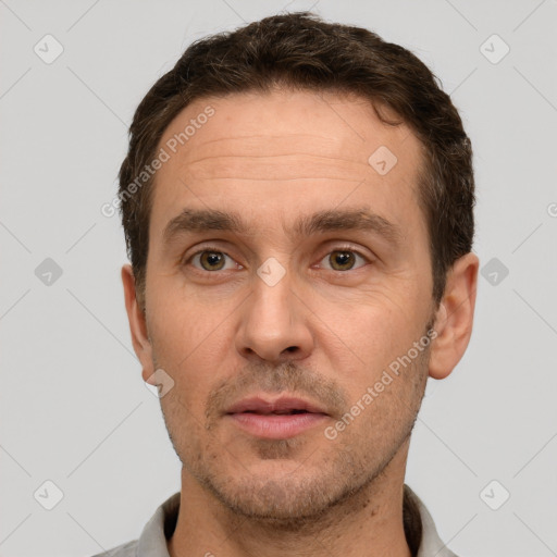 Joyful white adult male with short  brown hair and brown eyes