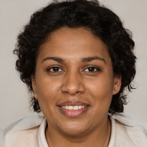 Joyful black young-adult female with medium  brown hair and brown eyes