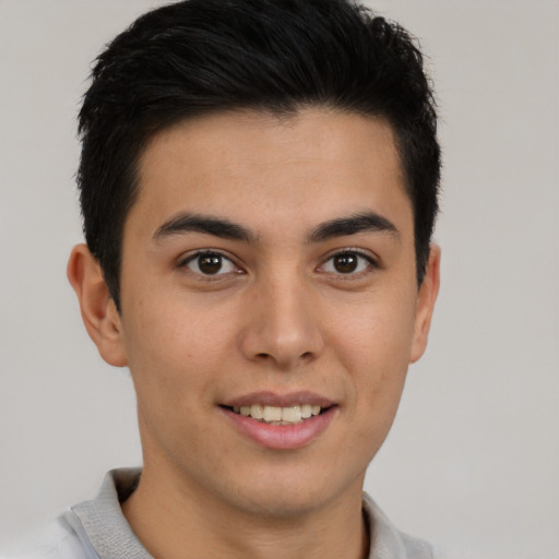 Joyful latino young-adult male with short  brown hair and brown eyes