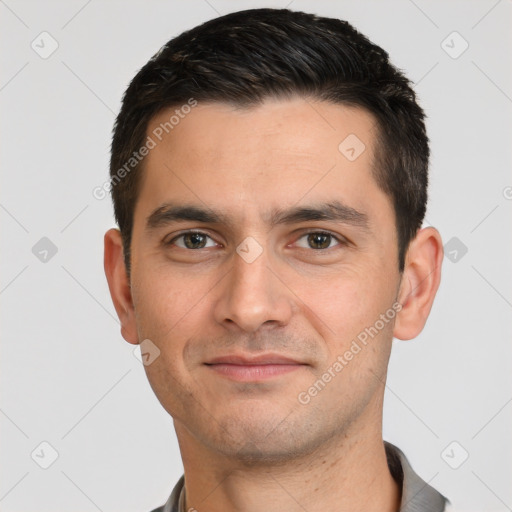 Joyful white young-adult male with short  black hair and brown eyes