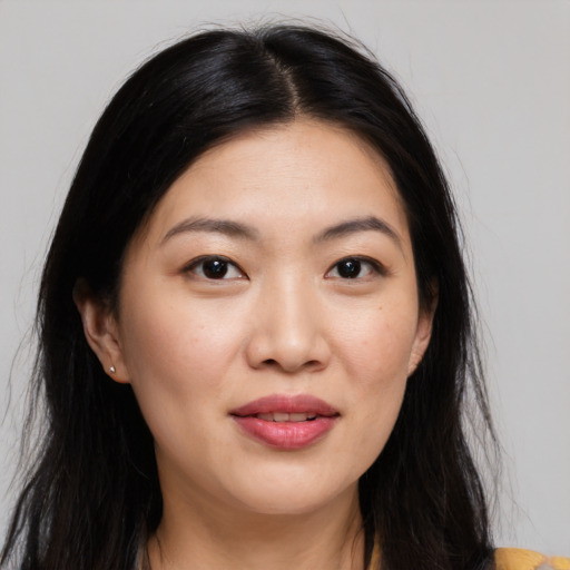 Joyful asian young-adult female with long  brown hair and brown eyes