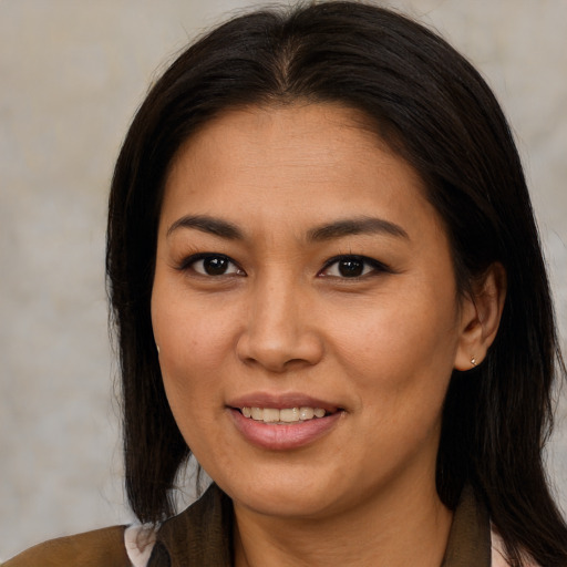 Joyful asian young-adult female with long  brown hair and brown eyes