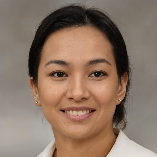 Joyful latino young-adult female with medium  brown hair and brown eyes