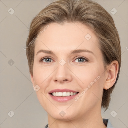 Joyful white young-adult female with medium  brown hair and grey eyes