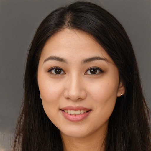 Joyful asian young-adult female with long  brown hair and brown eyes