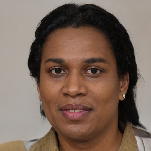Joyful black adult female with medium  black hair and brown eyes