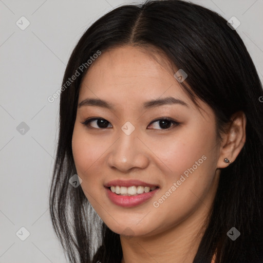 Joyful asian young-adult female with long  brown hair and brown eyes