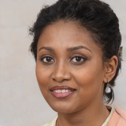 Joyful black young-adult female with medium  brown hair and brown eyes