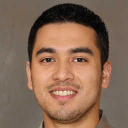 Joyful latino young-adult male with short  black hair and brown eyes